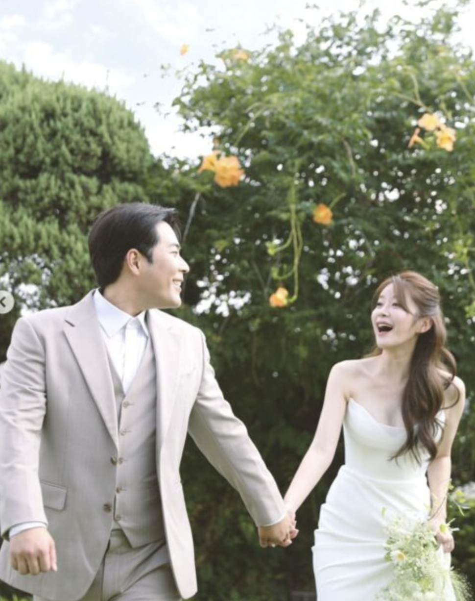 This contains an image of  Kim Hae Jun on a suit and  Kim Seung Hye on a wedding gown looking wonderful