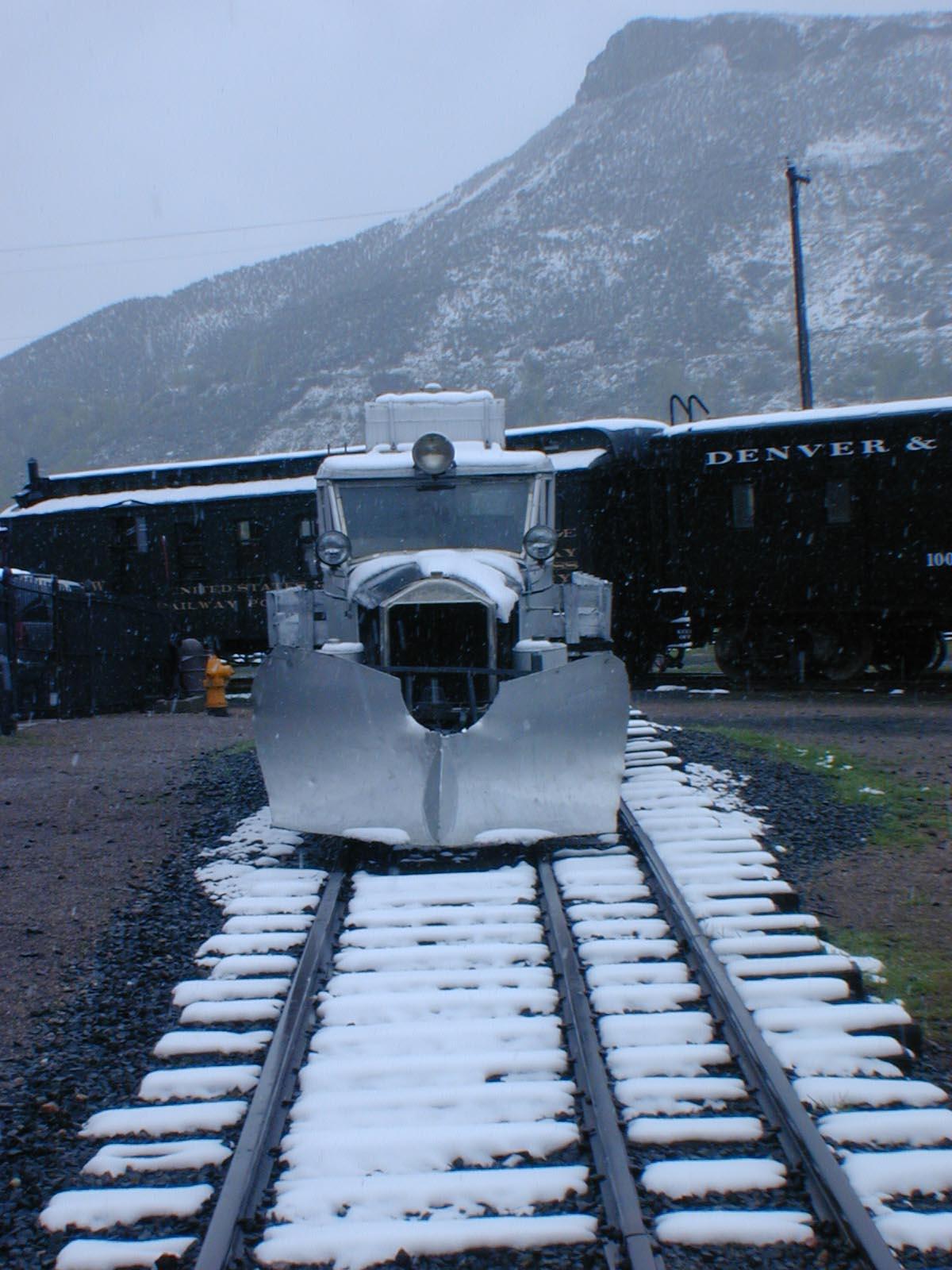 A train on the tracks covered in snow

Description automatically generated