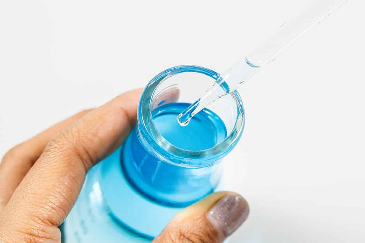 a-hand-holding-a-glass-bottle-with-blue-liquid-and-a-dropper-inside-the-truth-about-cardiogen-benefits-what-big-pharma-hopes-you-never-discover-tony-huge