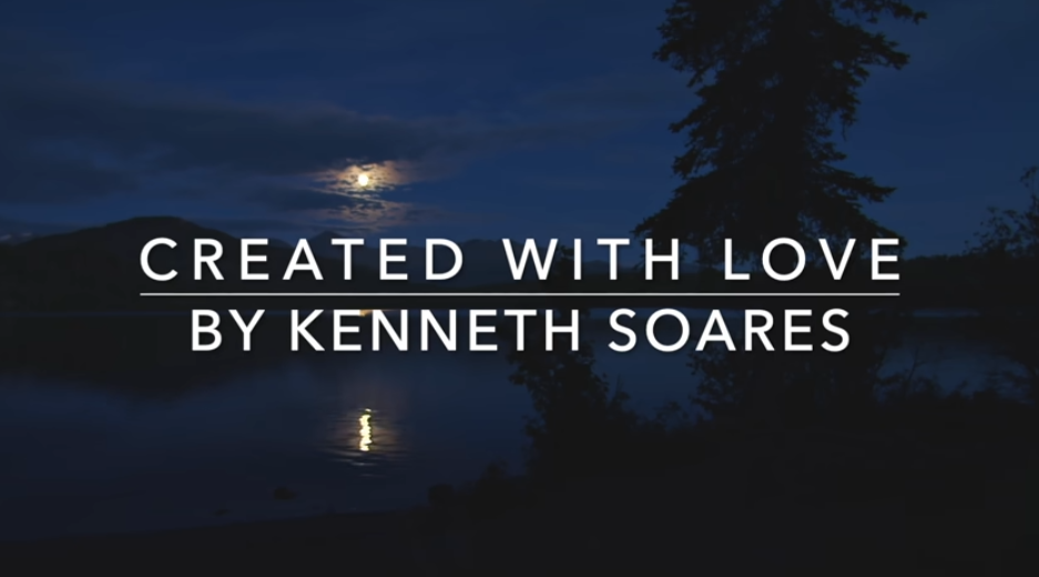 Peaceful night view of a lake featuring the reflection of trees and moon in water, displaying text "Created with Love by Kenneth Soares"