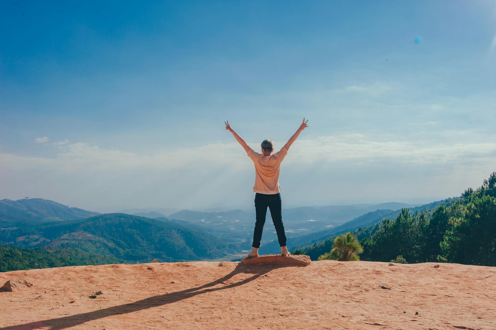 person on top of a mountain building healthy habits