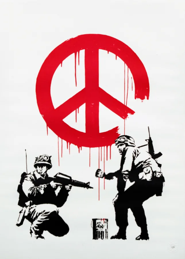 In this famous art about war, Banksy’s CND Soliders shows 2 soldiers painting red peace sign art on a wall