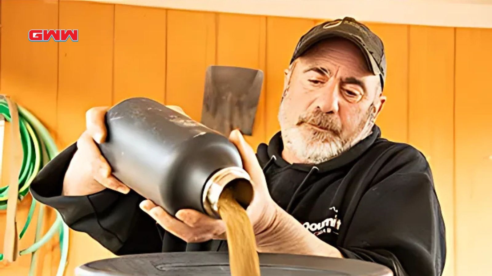 Gold Rush miner Tony Beets pouring gold dust into a container during operations