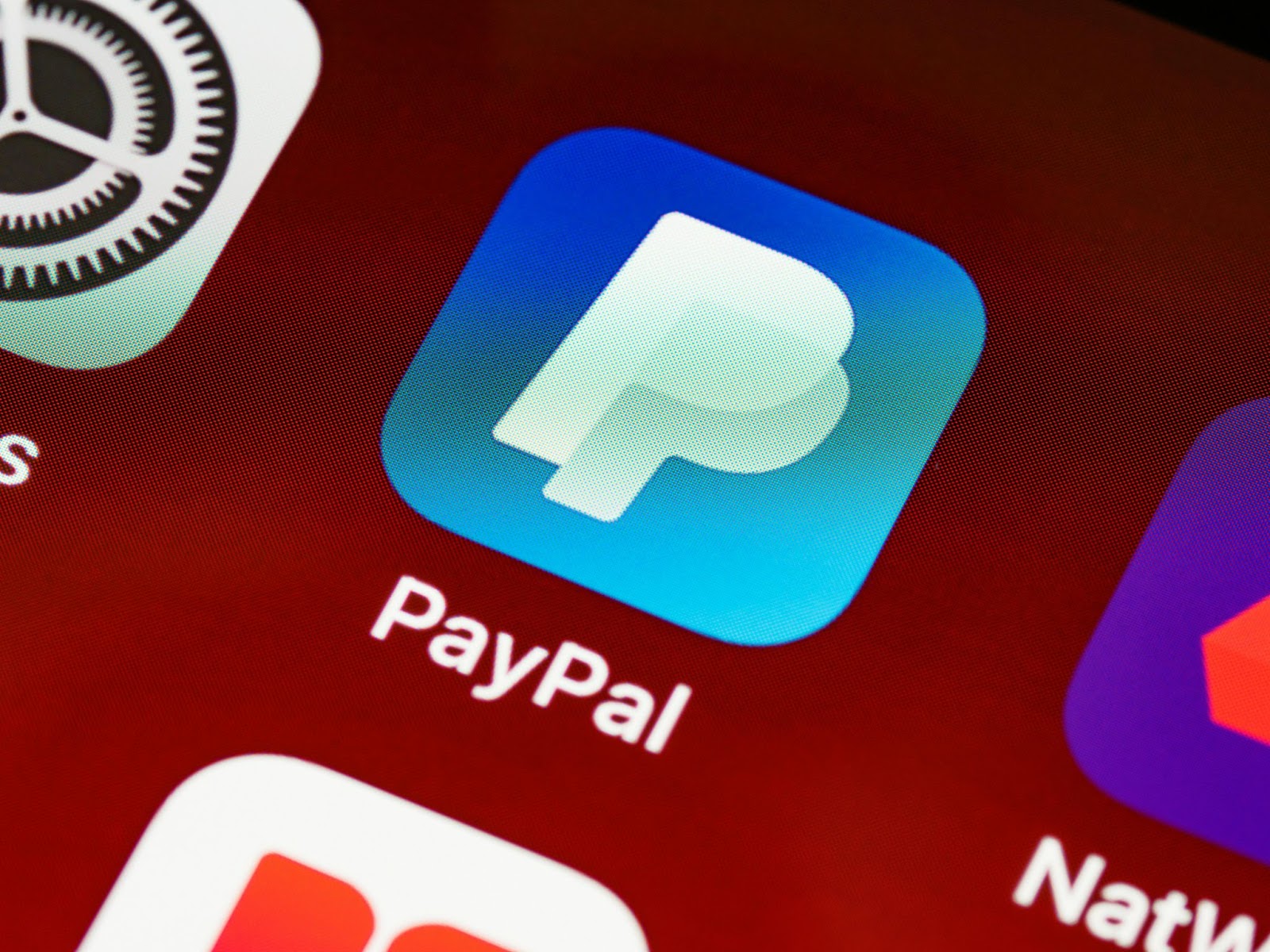 Close-up of a smartphone app screen showing the PayPal logo on a device's app drawer