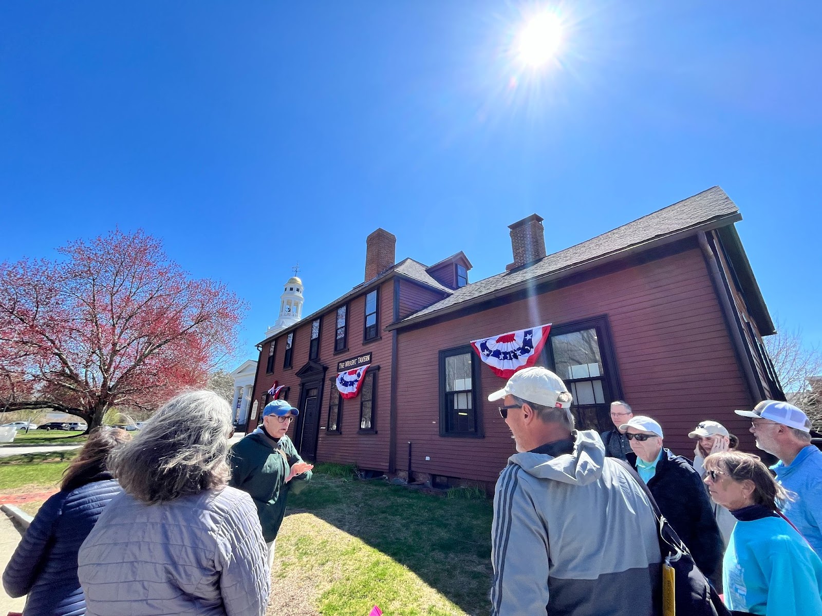 Group of people around a tour guide hearing the history of Wright Tavern in Concord, Massachusetts 