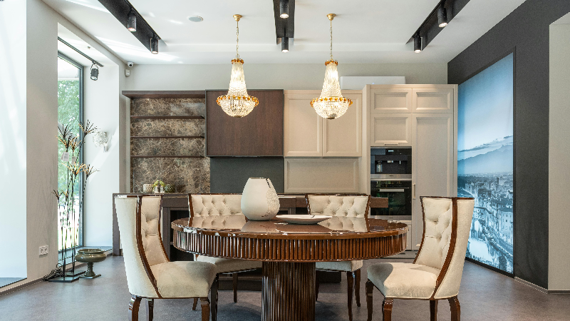 Two small chandeliers hanging above a table 