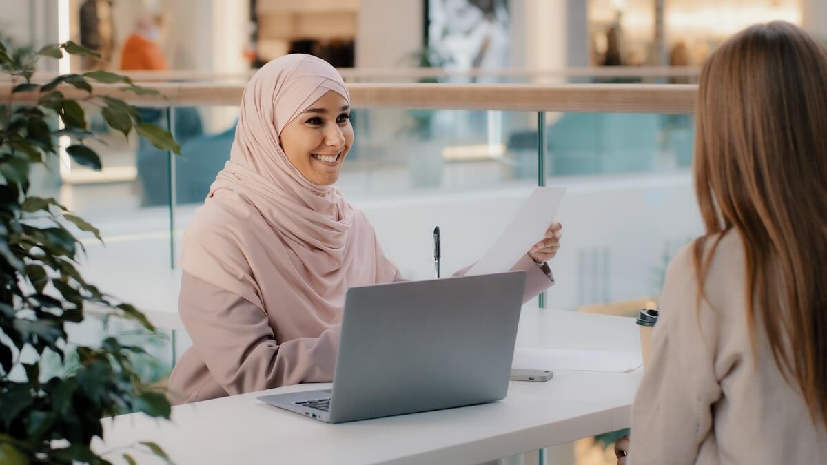 HR staff handing a document to an employee