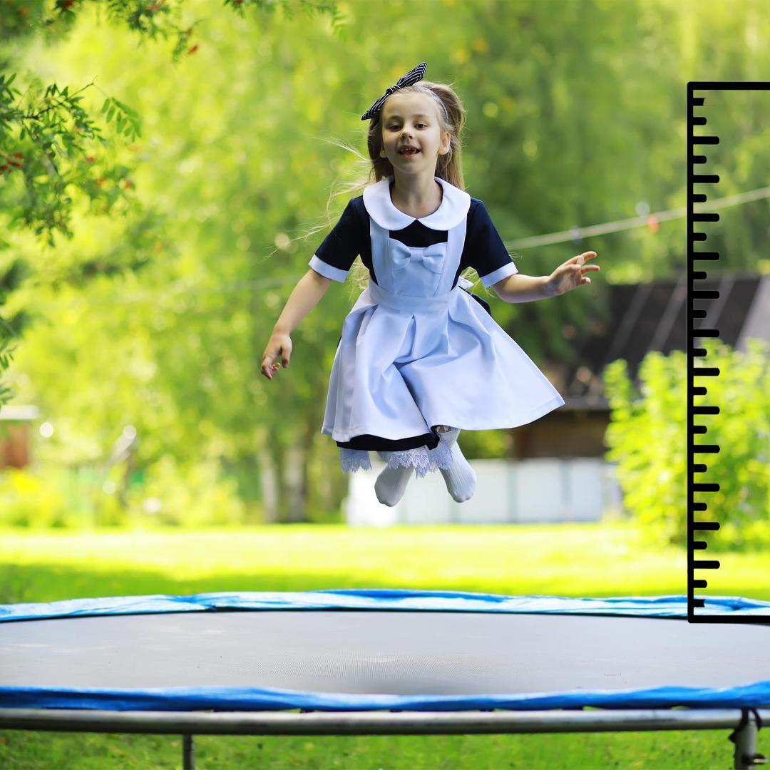 Little Girl Wearing Frock Jumping on Round Trampoline - supertramp.co.uk