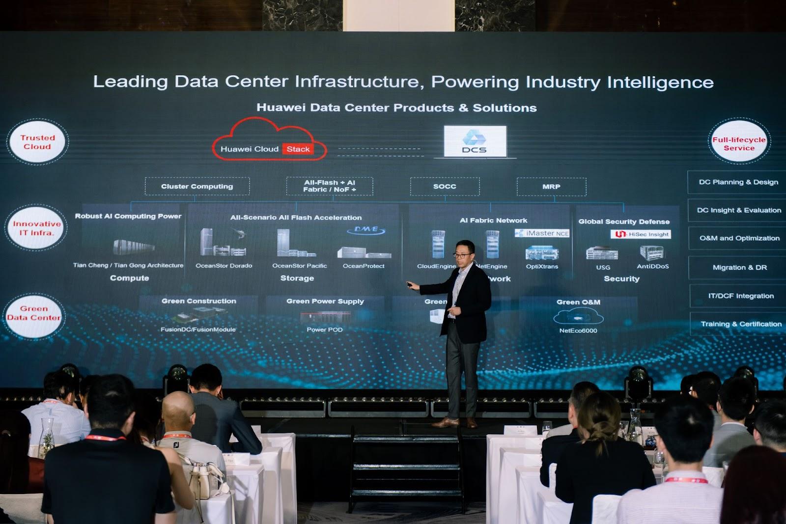 A person standing on stage with a large screenAI-generated content may be incorrect.