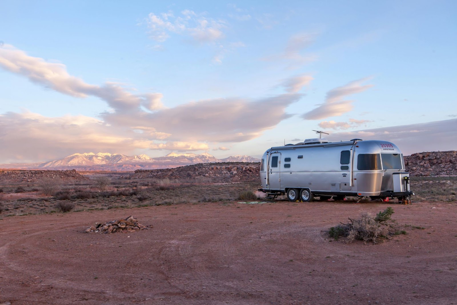 grey and black RV under blue and white sky