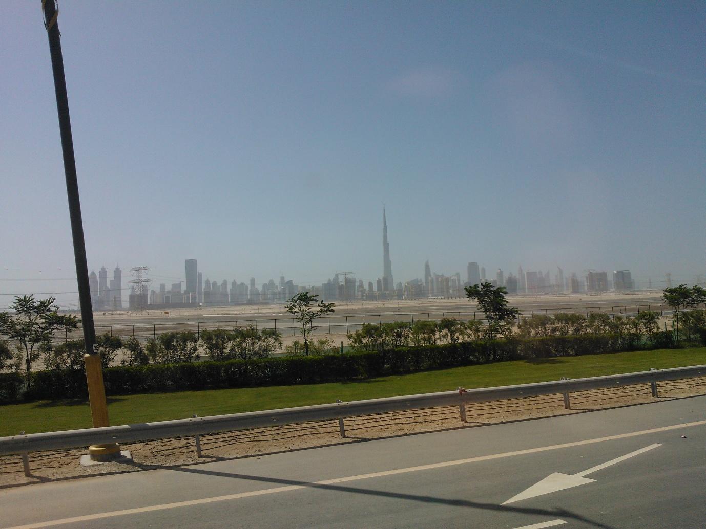 A road with a city in the background

