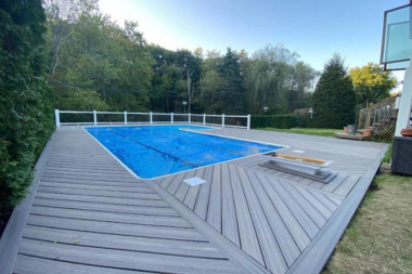 making a decking splash comparing composite pool deck designs herringbone pattern with railing overlooking forest custom built michigan