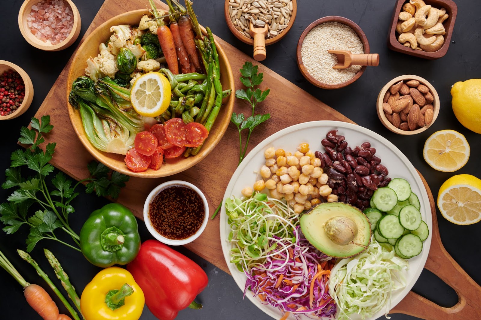 Fruits, dryfruits and veggies are kept on a cooking table.