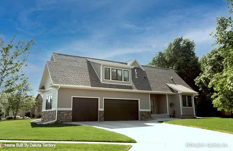 Side exterior view with a small porch and an oversized garage topped with a shed dormer.