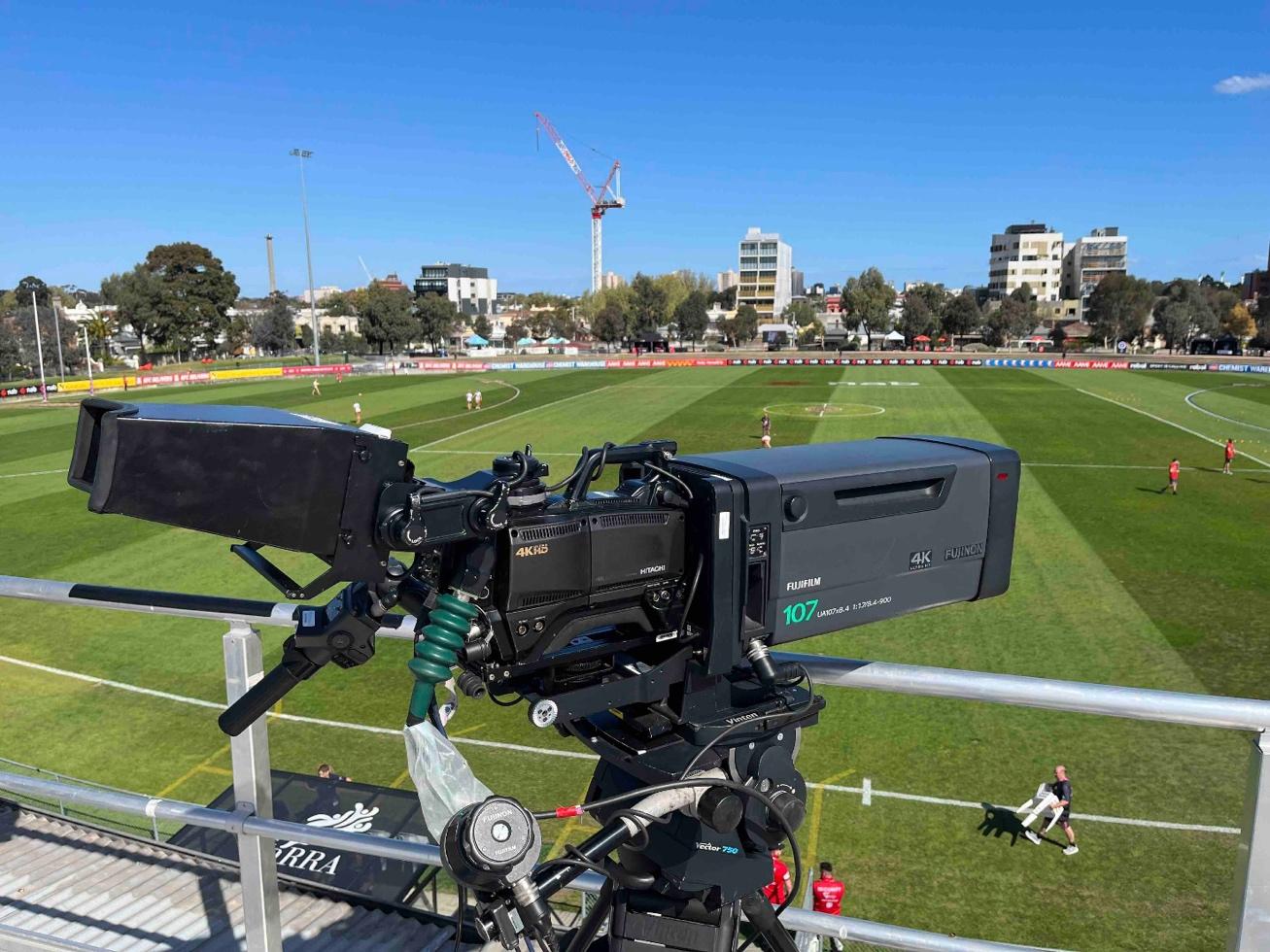 A camera on a stand on a football field

Description automatically generated