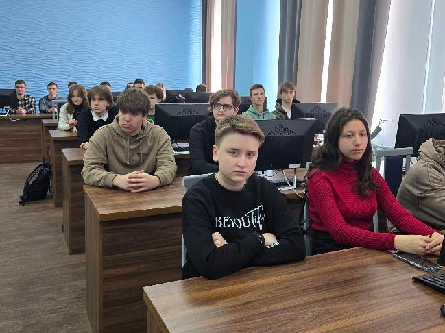 A group of people sitting at desks in a classroomAI-generated content may be incorrect.