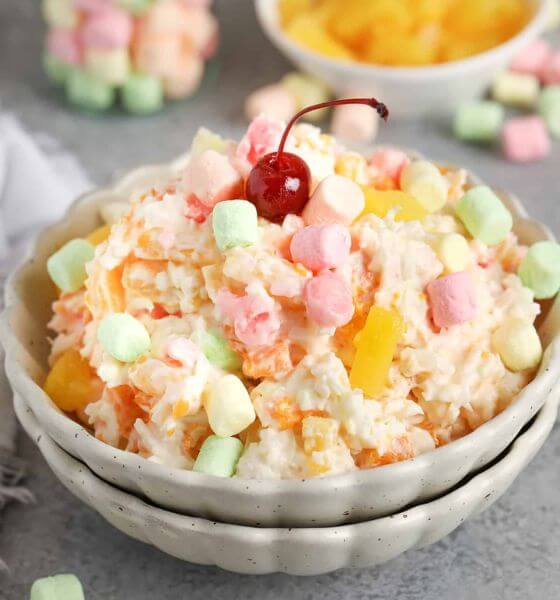 Ambrosia salad with marshmallows and fruit in a white bowl