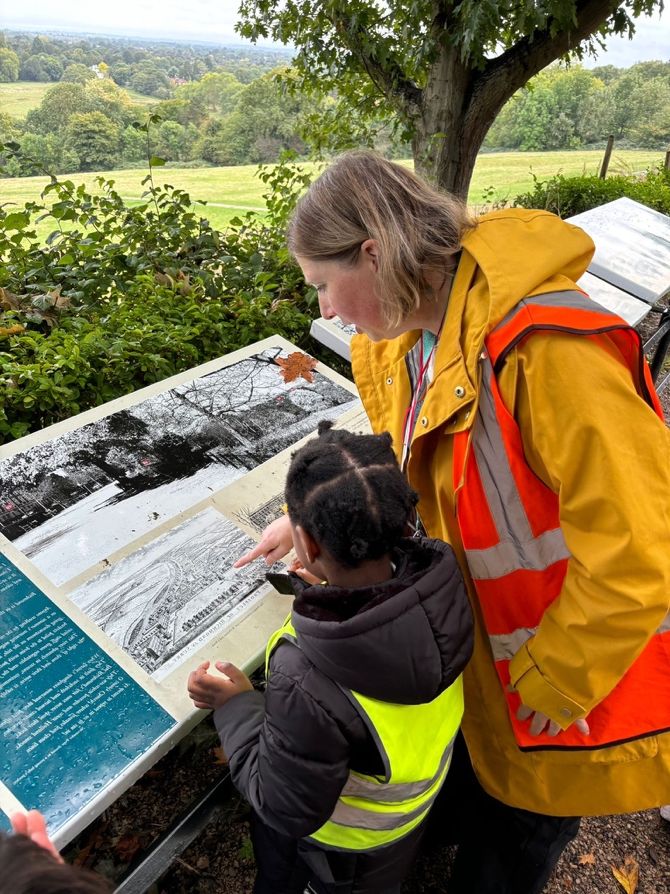 A person and child looking at a map

Description automatically generated