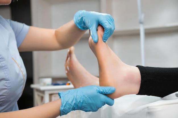 Professional foot massage to woman in beauty salon