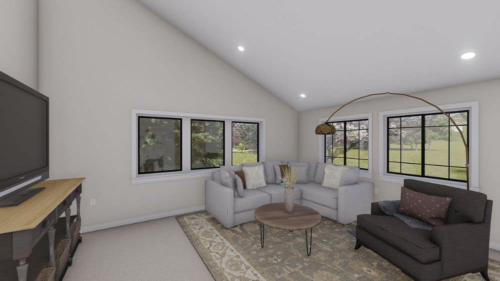 Sitting room with L-shaped sectional, gray armchair, a round coffee table, and a TV placed above the wooden cabinet.Sitting room with L-shaped sectional, gray armchair, a round coffee table, and a TV placed above the wooden cabinet.