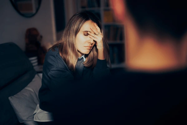 A woman is seen stressed with her partner.