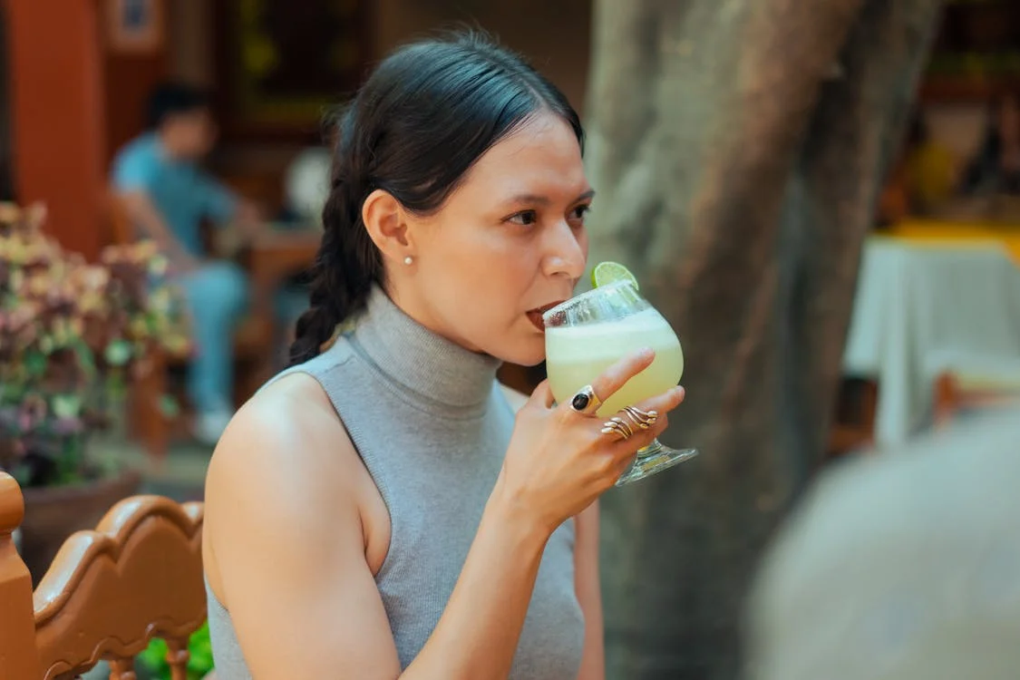 a woman drinking margarita