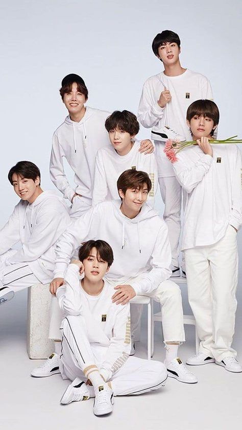 This  contain an image of members of btop are posing for a photo in their white outfits and holding flowers