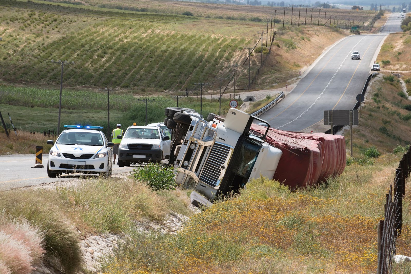 Police helping a truck after an accident.