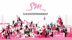 This contain an image of large group of people standing in front of a pink wall with the words sm entertainment on it