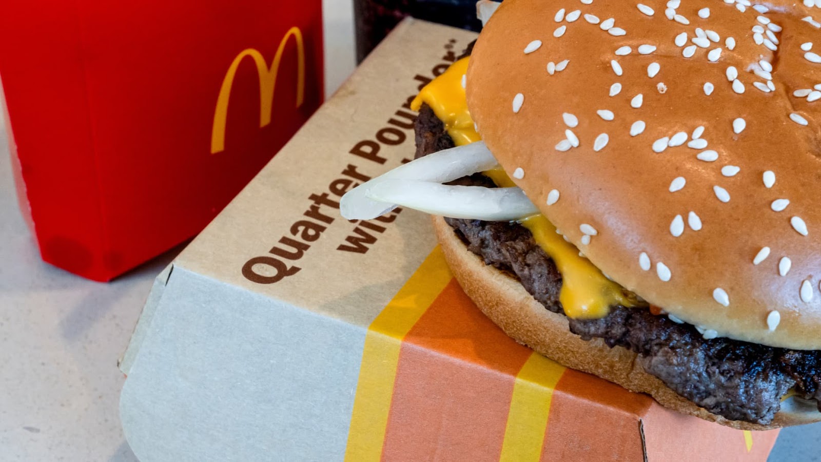 A quarter pounder with cheese, fries, and a drink arranged at a McDonald's restaurant in El Sobrante, California, US, on Wednesday, Oct. 23, 2024. McDonald's Corp. is trying to contain the fallout from a severe E. coli outbreak that appears to be linked to onions in its Quarter Pounder sandwiches, which has killed one person and sickened dozens of people across the US. Photographer: David Paul Morris/Bloomberg via Getty Images