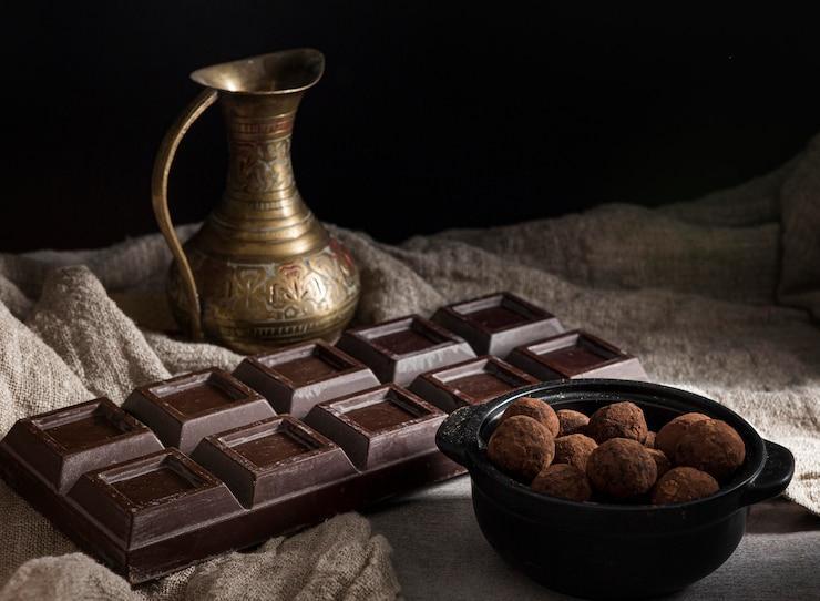 High angle chocolate bar and round candies