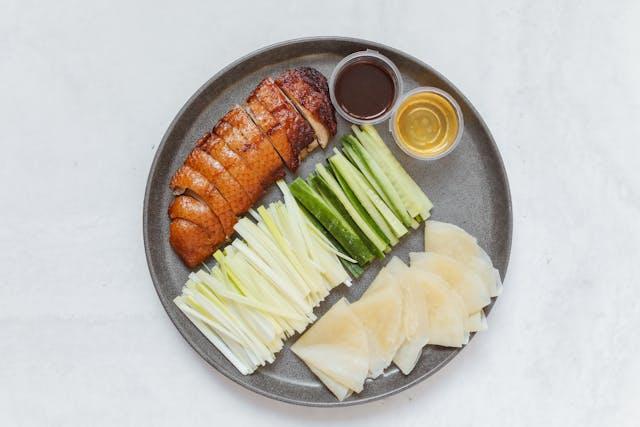 A plate of food with sauces

Description automatically generated