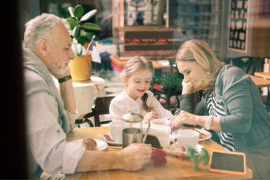 how a home remodeling project can positively impact your family grandparents having breakfast with grandchild at table custom built michigan