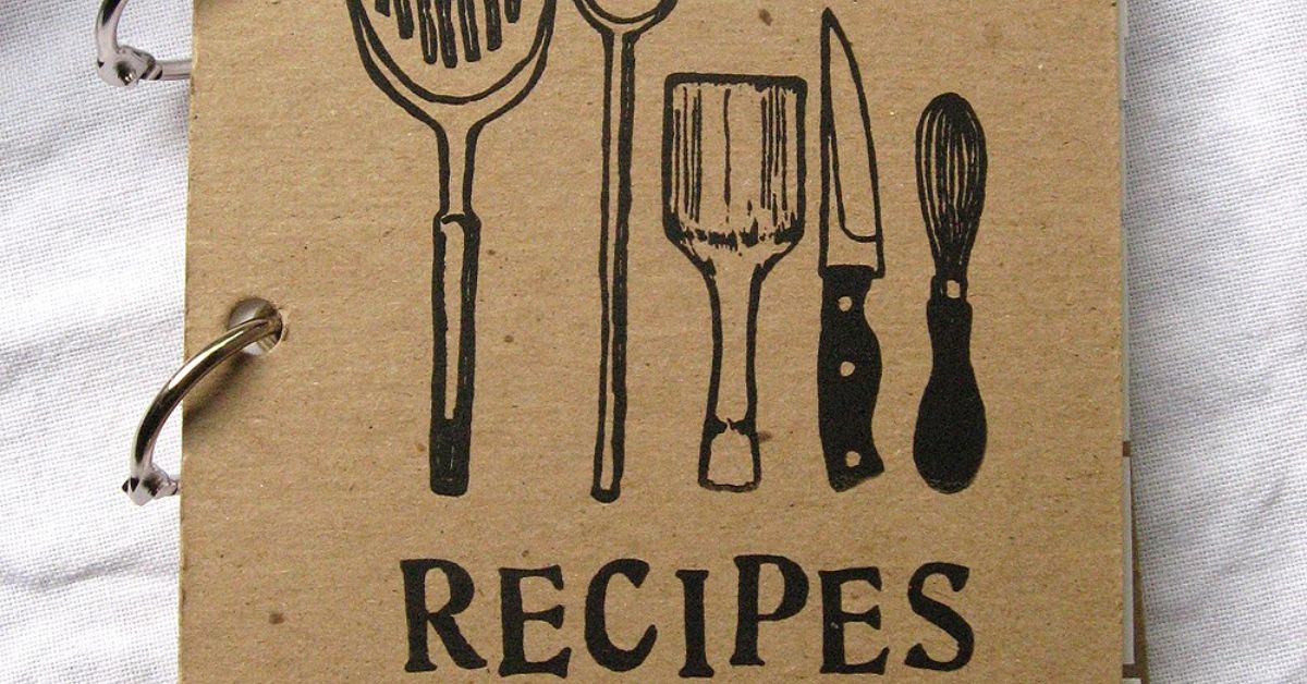 A recipe book featuring a drawing of kitchen utensils, symbolizing the art of cooking and culinary creativity.