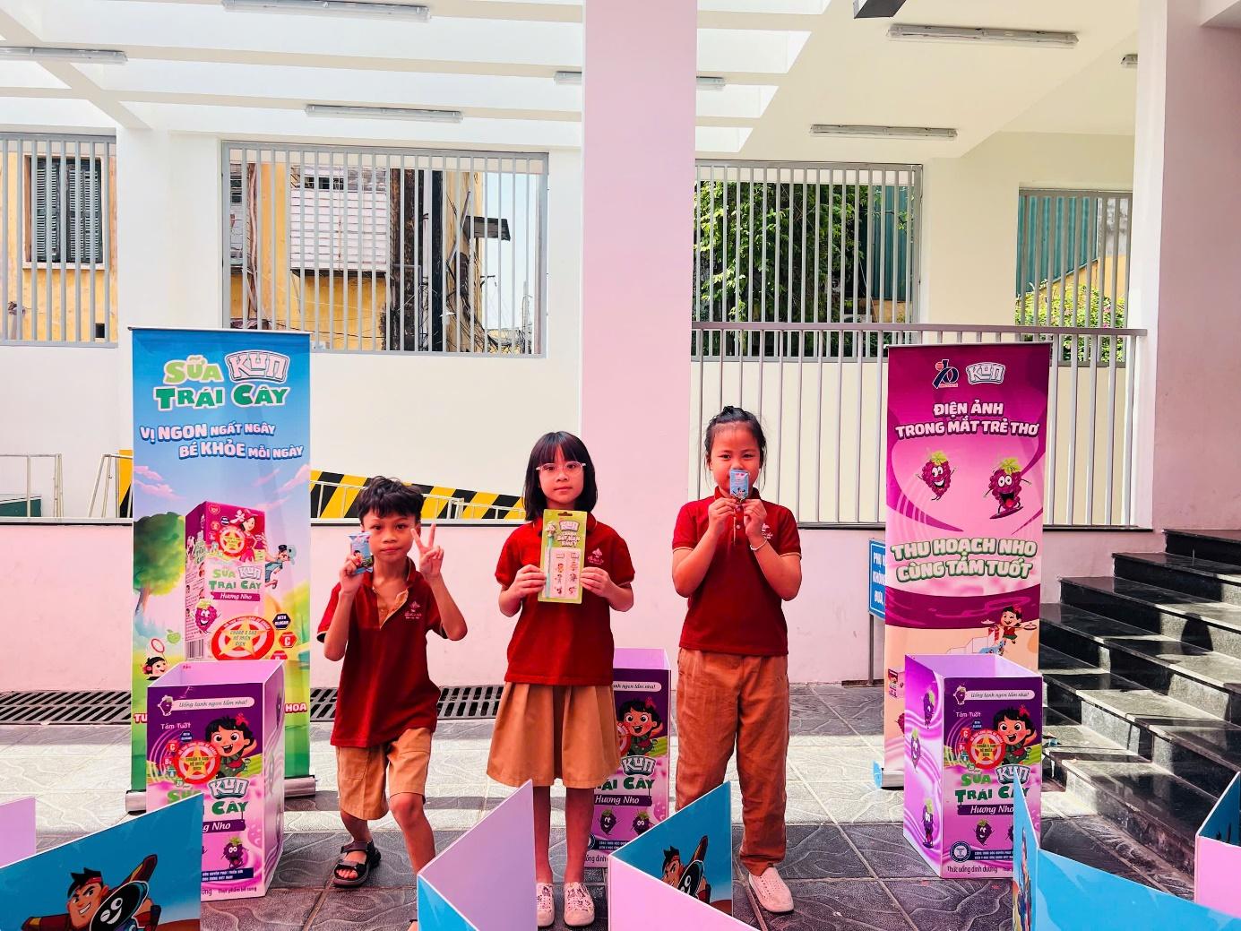 A group of children standing in front of a building

Description automatically generated