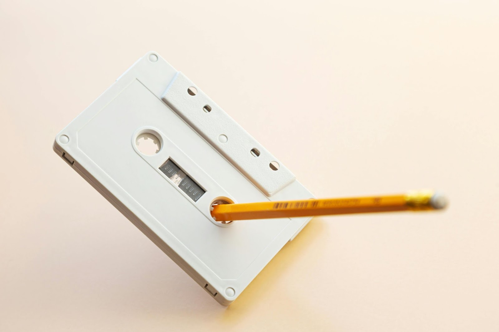 Yellow Pencil on White Cassette Tape.