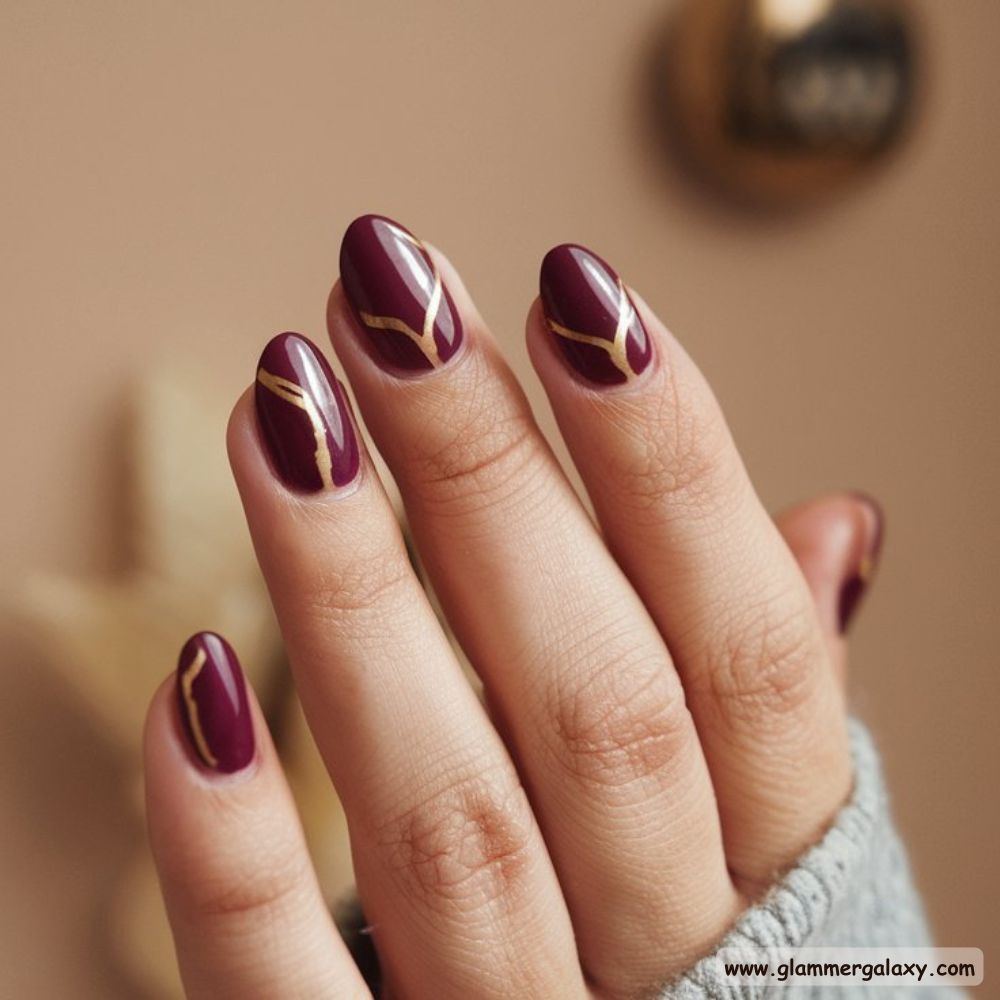 Classy Fall Nails having Plum Nails with Golden Highlights