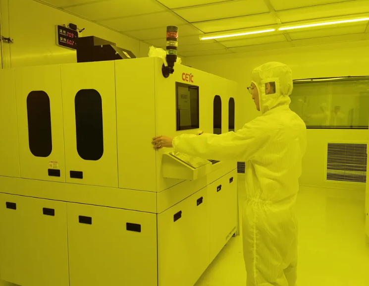 A person in a white suit and hazmat suit standing in a room with a machine

AI-generated content may be incorrect.
