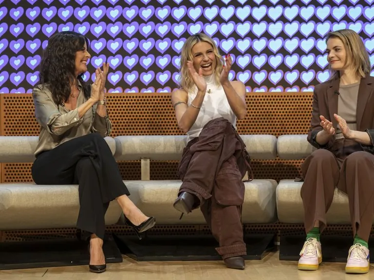 Sandra Studer, Michelle Hunziker, and Hazel Brugger smile as they are announced as Eurovision 2025 hosts during a media event. Source: Georgios Kefalas/KEYSTONE/dpa.