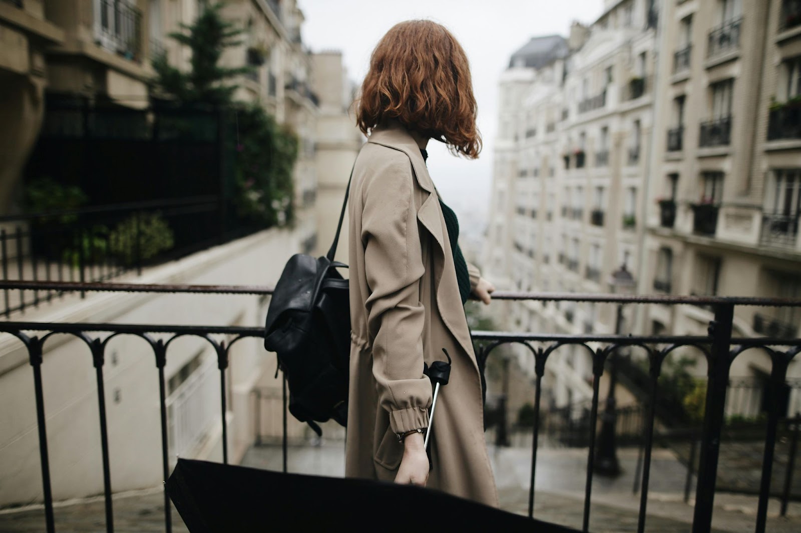 A woman holding an umbrella in the citry