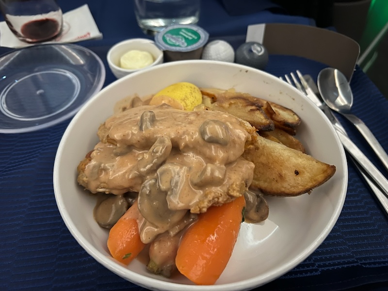 A schnitzel dish served onboard United Polaris Business Class flight to Frankfurt, Germany. 