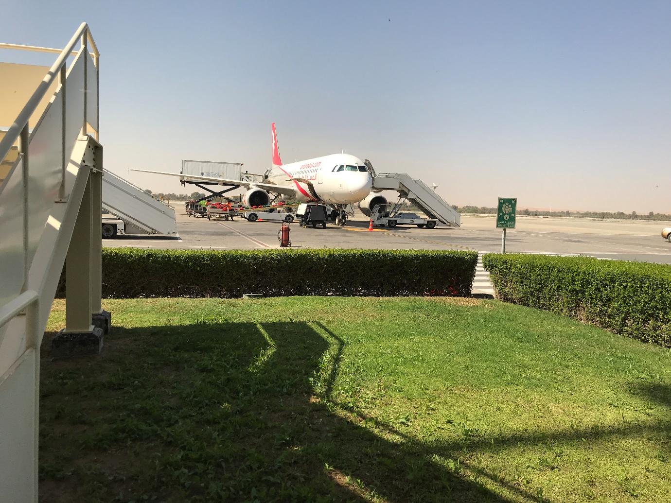  A plane parked on the tarmac at an airport, symbolizing the booming RAK real estate market attracting Dubai and Abu Dhabi buyers.
