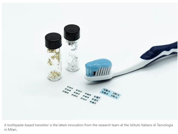 A toothbrush and small bottles of toothpaste

Description automatically generated