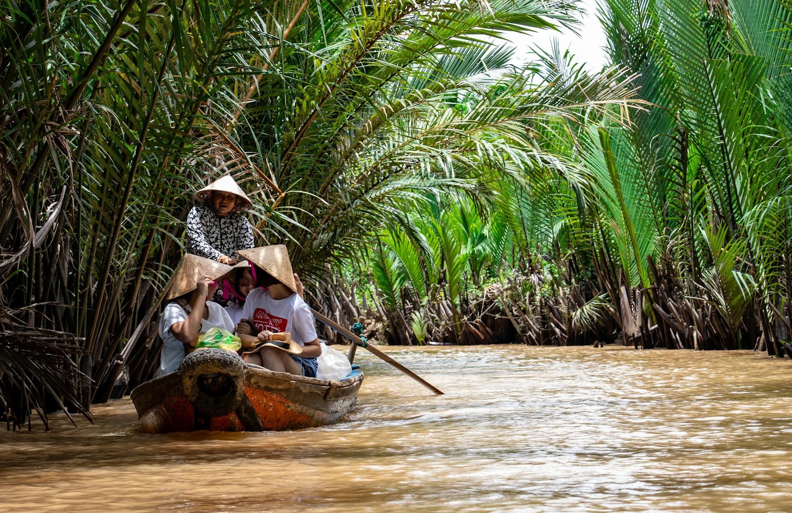 A group of people in a boat on a river

Description automatically generated