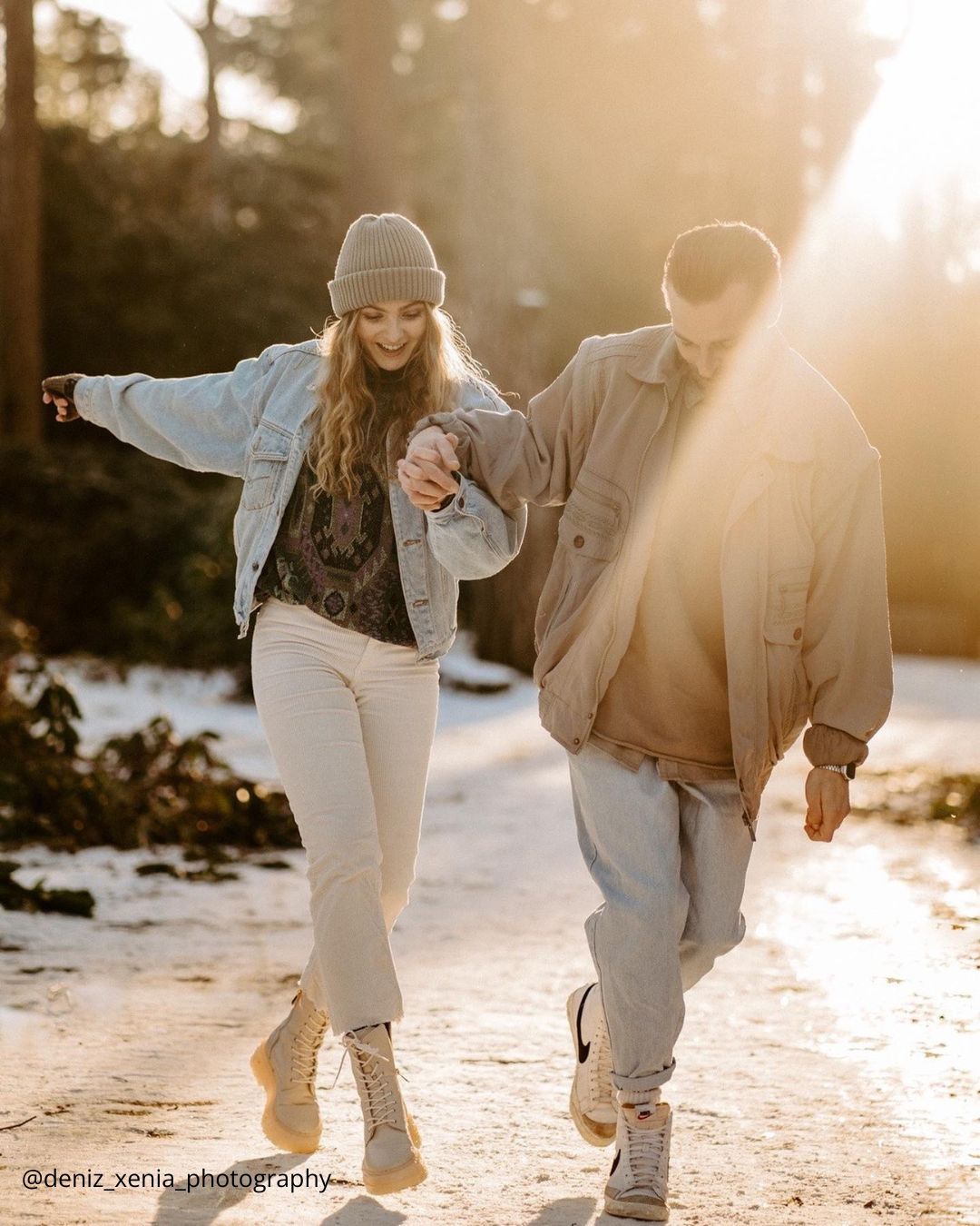 winter engagement photos a couple dancing in the snow