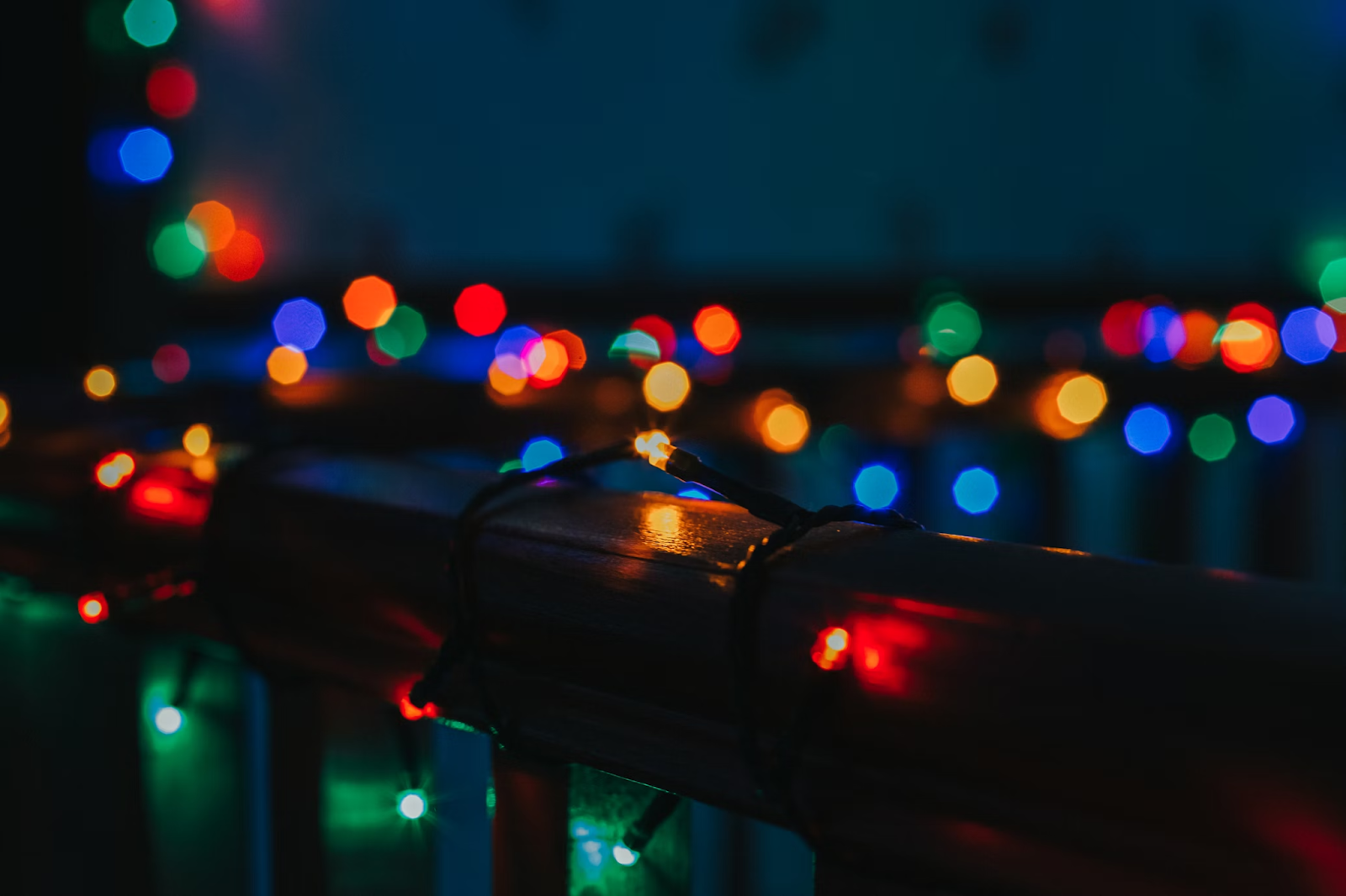 Photo of colored Christmas lights wrapped around a handrail.