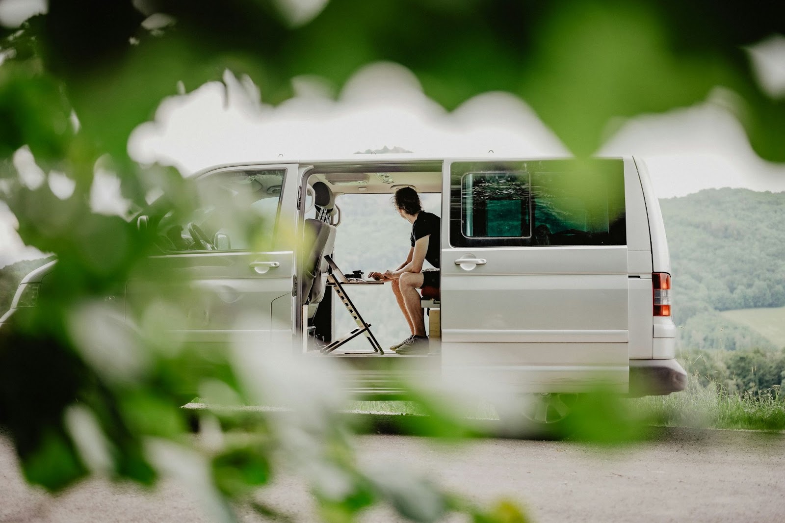 Nomadic man working from inside a van