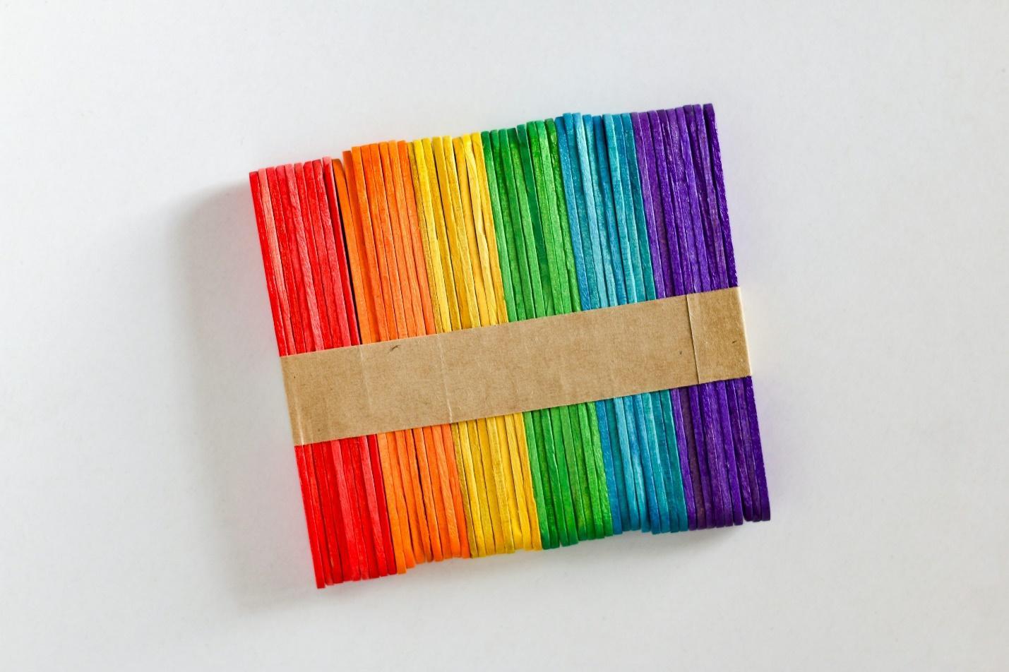 A piece of paper that has been folded in rainbow colors