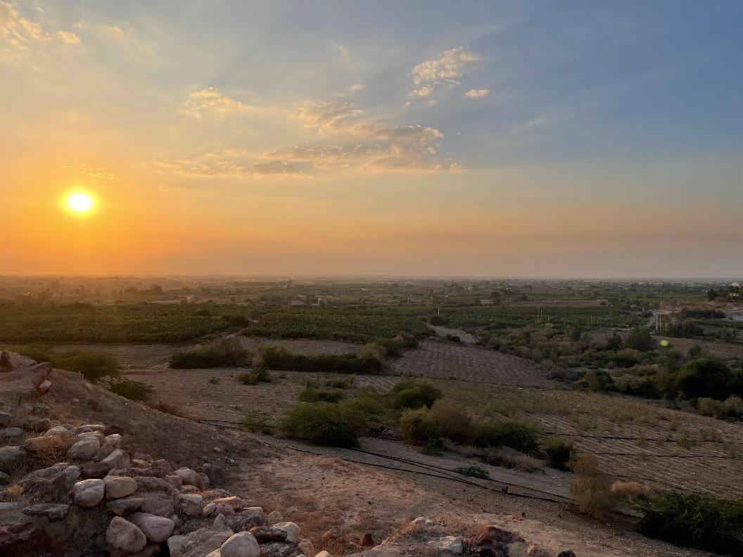 A sunset over a landscape

