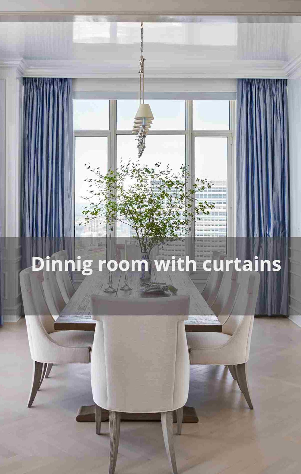 A dining room with light blue curtains accent